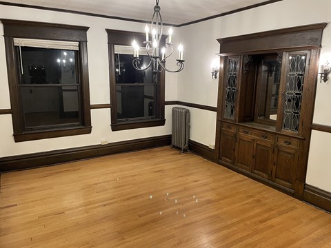 A room with wooden floors and a chandelier.
